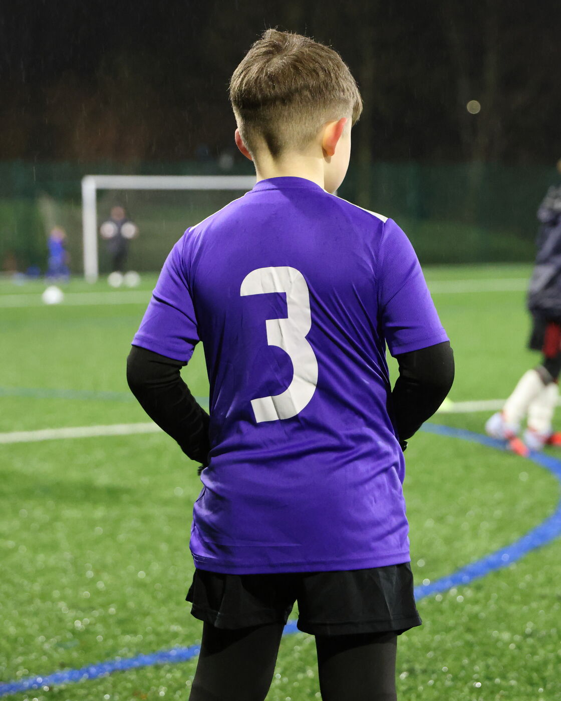 NextGen player in the number three shirt watching play