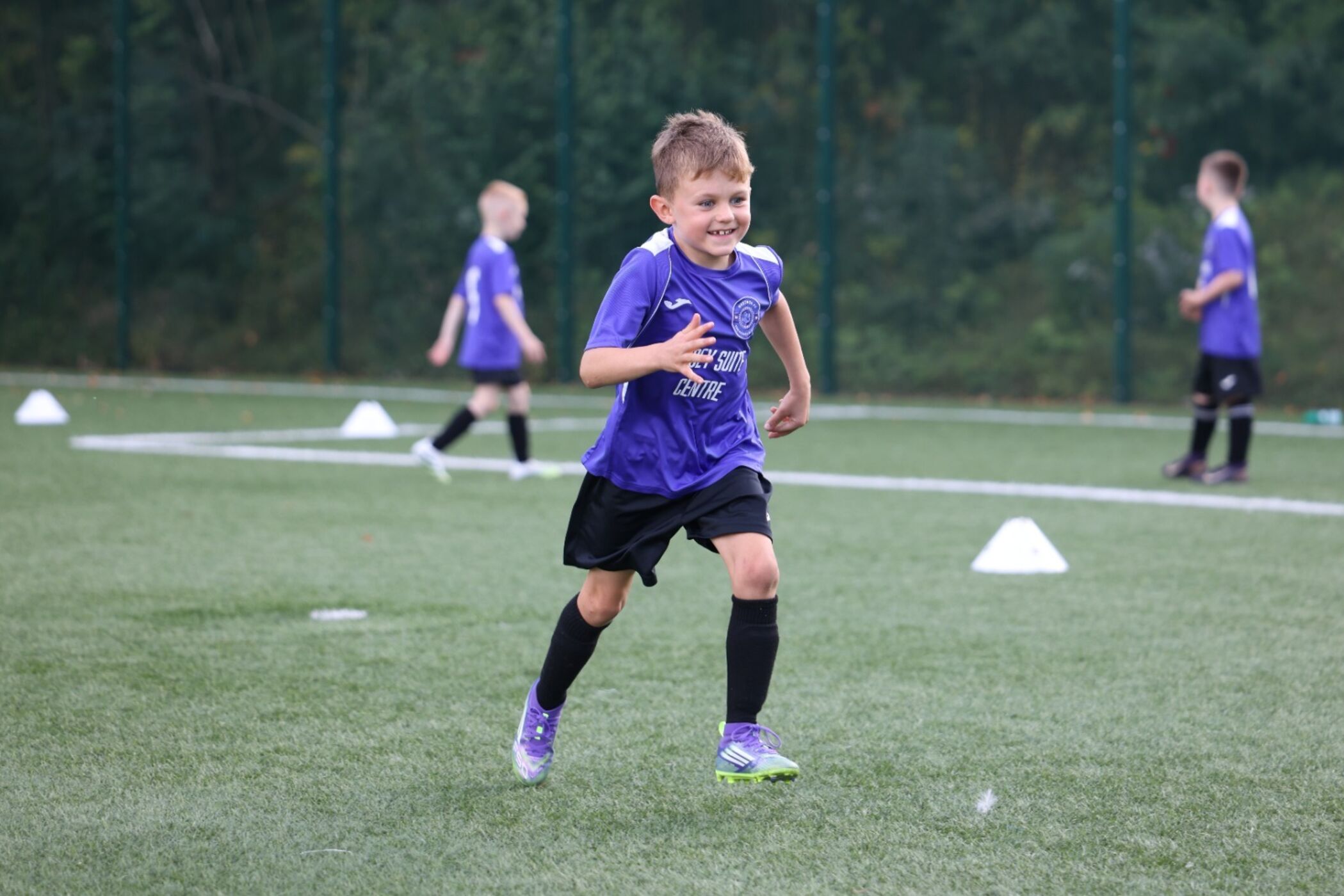 NextGen player smiling as he runs during a session