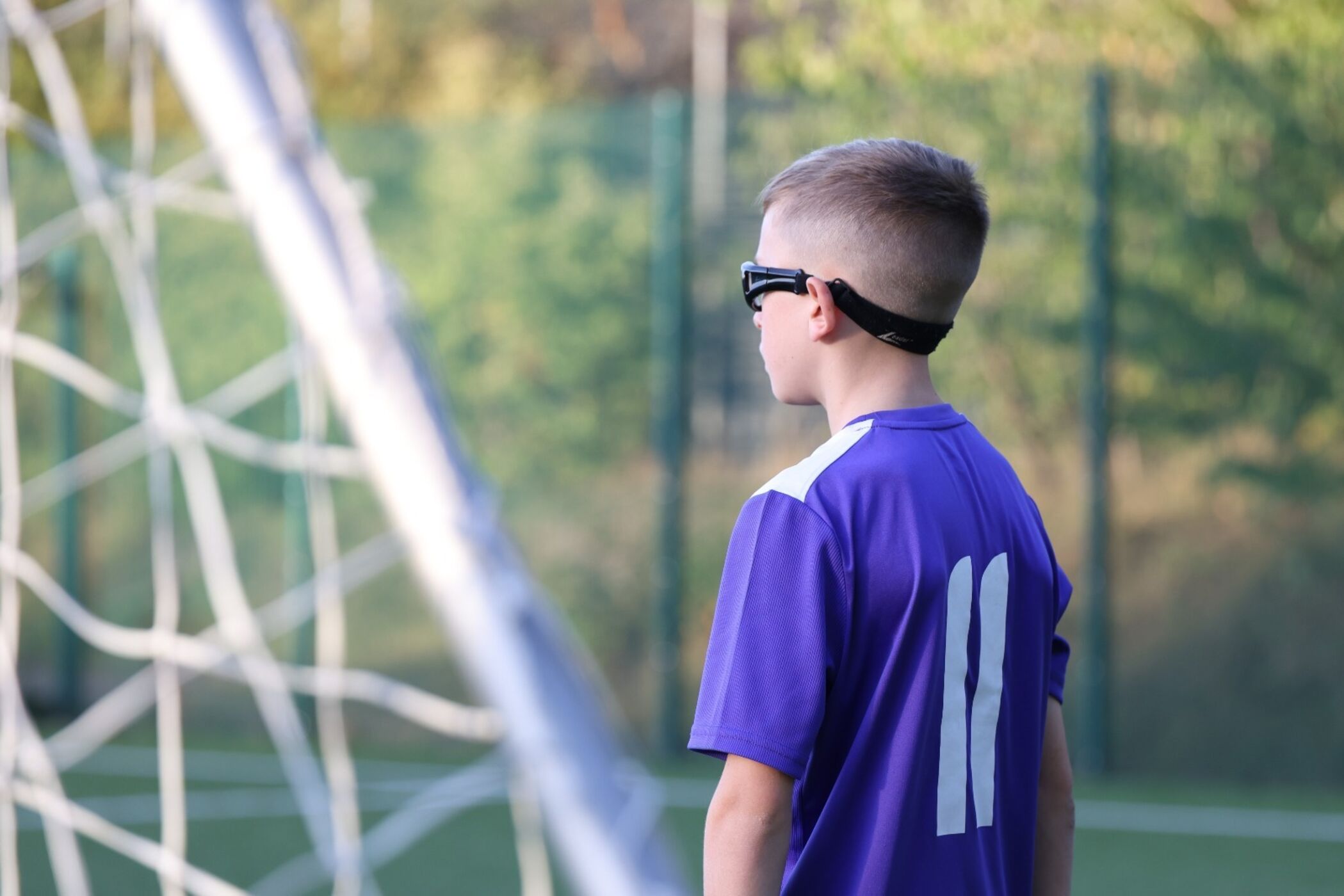Player watching on from beside the goal